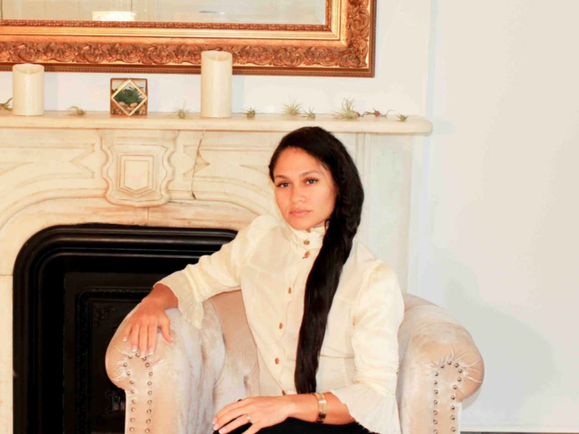 Erica Gomez-Ratush, DO, seated by the fireplace in the PURR office